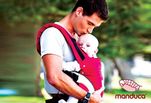 A Manduca Promotional Image Featuring A Babywearing Dad